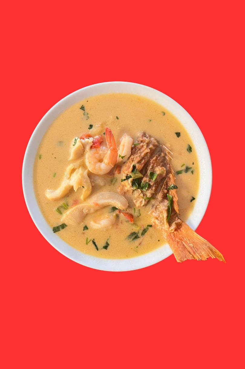 Honduran seafood soup with whole fish, shrimp, and other seafood in a creamy broth.