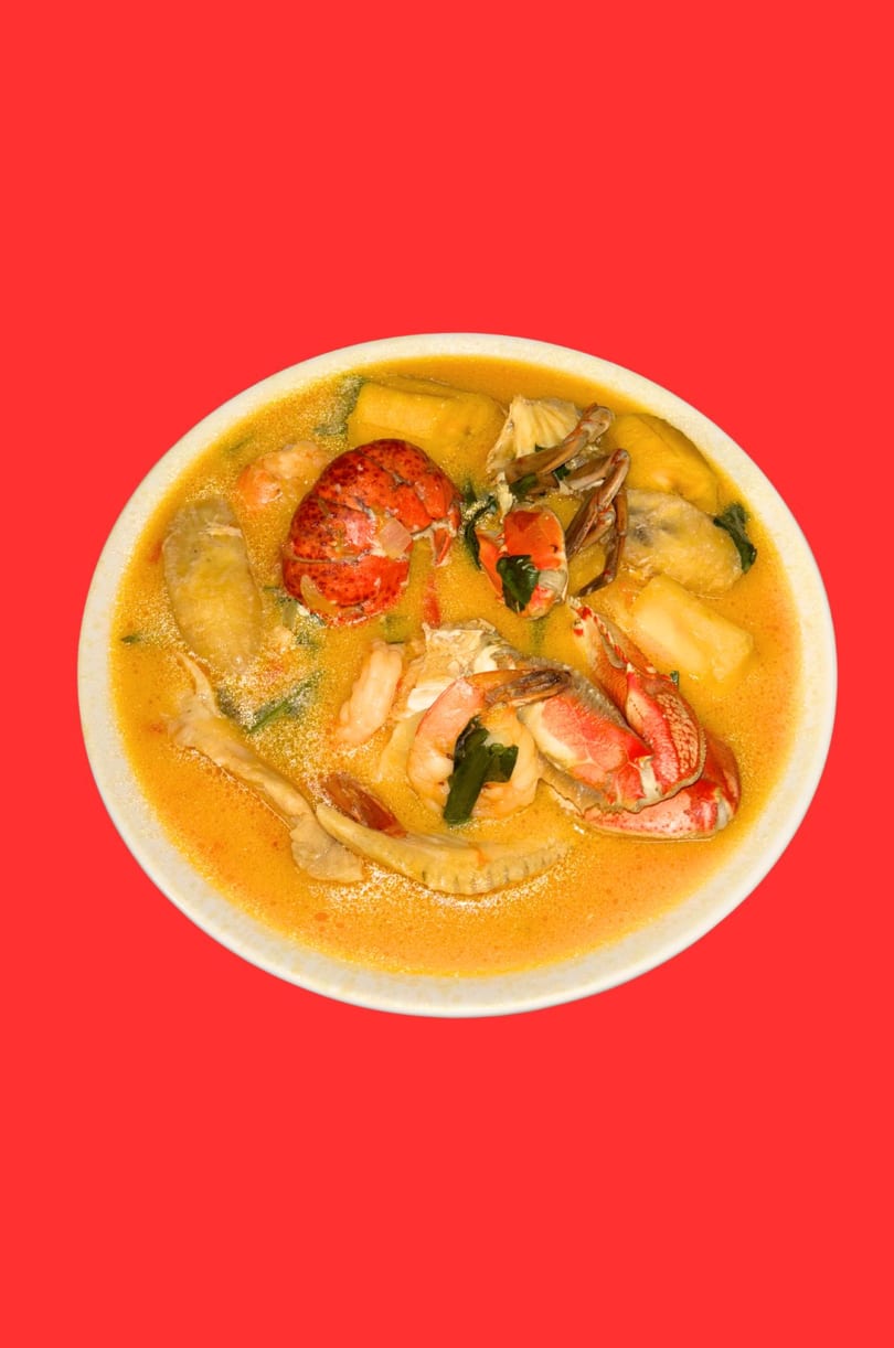 Honduran seafood soup with lobster, crab, shrimp, and vegetables in a rich orange broth.
